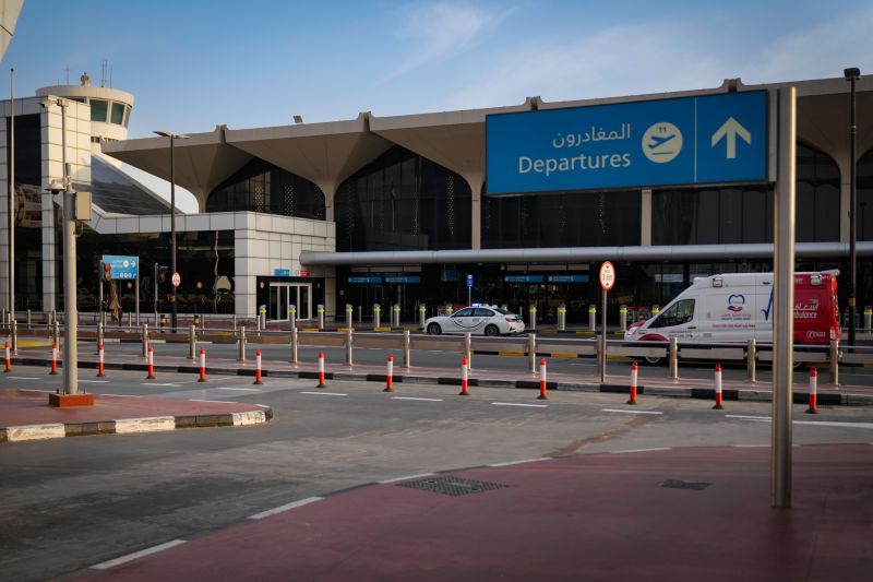 A police vehicle and an ambulance are parked on the departure road of Dubai International Airport as it lies deserted following its closure in Dubai, United Arab Emirates, on March 1, 2026.