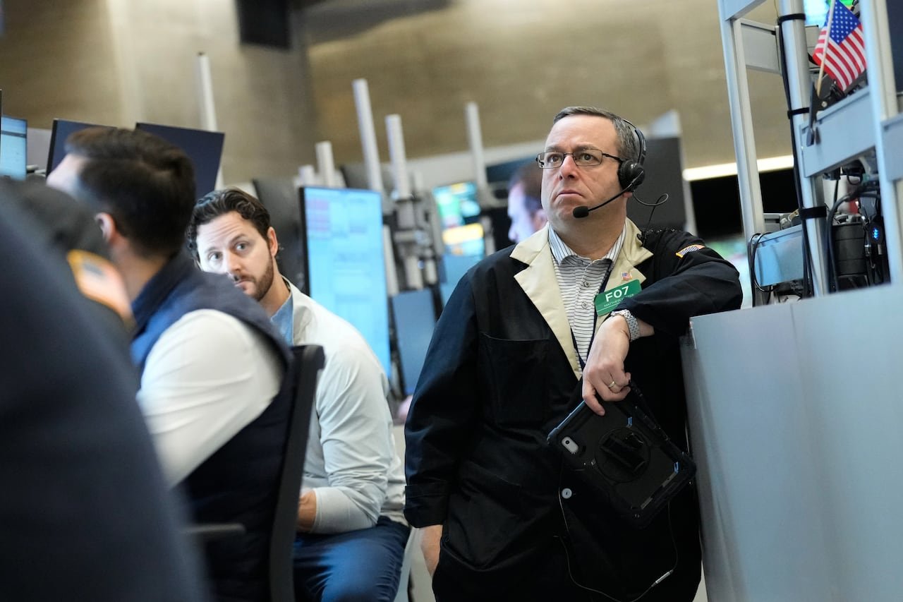 a man with a headset looks upset, looking at a screen in the distance