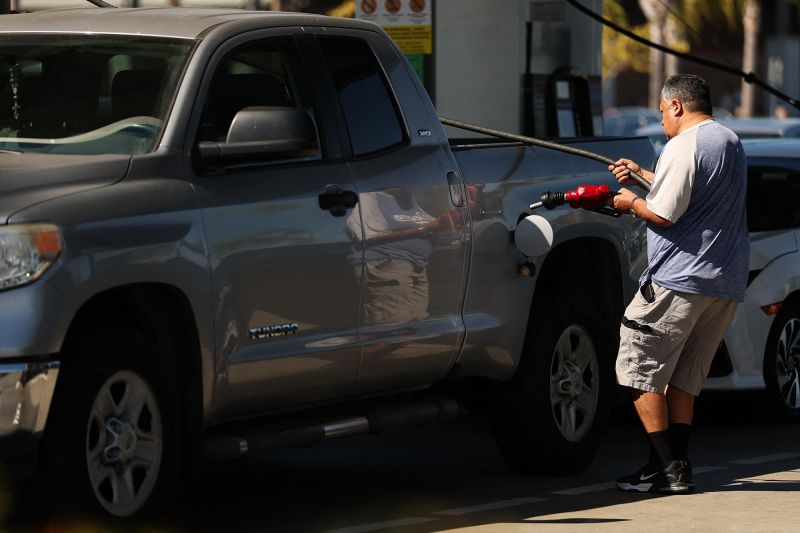 A driver pulls the gasoline pump hose to fill his truck tank at a gas station in the Marina Del Rey community of Los Angeles on March 2, 2026.