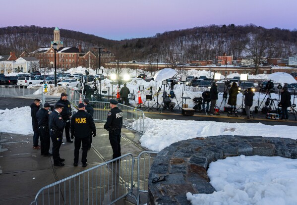 Law enforcement personnel and members of the media gather outside the Chappaqua Performing Arts Center while awaiting the arrival of former President Bill Clinton who is testifying before U.S. House lawmakers as part of a congressional investigation into convicted sex offender Jeffrey Epstein, Friday, Feb. 27, 2026, in Chappaqua, N.Y. (AP Photo/Angelina Katsanis)