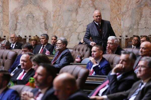 Rep. Jim Walsh, R-Aberdeen, walks off the House floor as Washington Gov. Bob Ferguson delivers his State of the State address during a joint legislative session at the Washington State Capitol, Jan. 13, 2026, in Olympia, Wash. (AP Photo/Lindsey Wasson)