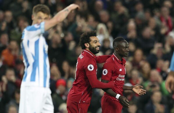 Liverpool's Mohamed Salah, centre, and Liverpool's Sadio Mane celebrate after scoring their side's second goal during the English Premier League soccer match between Liverpool and Huddersfield Town at Anfield Stadium, in Liverpool, England, April 26, 2019.(AP Photo/Jon Super, File)
