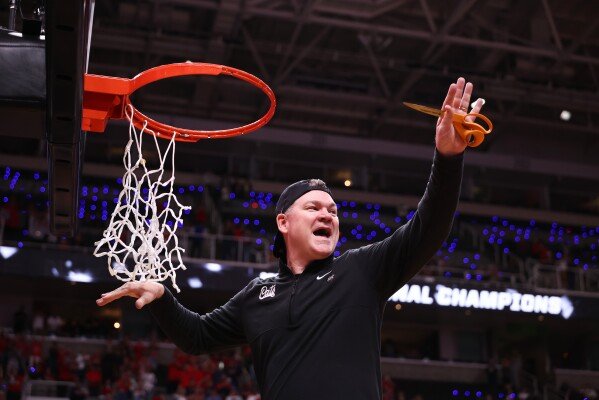 Arizona head coach Tommy Lloyd cuts down the net after a win over Purdue in the Elite Eight of the NCAA college basketball tournament, Saturday, March 28, 2026, in San Jose, Calif. (AP Photo/Kelley L Cox)