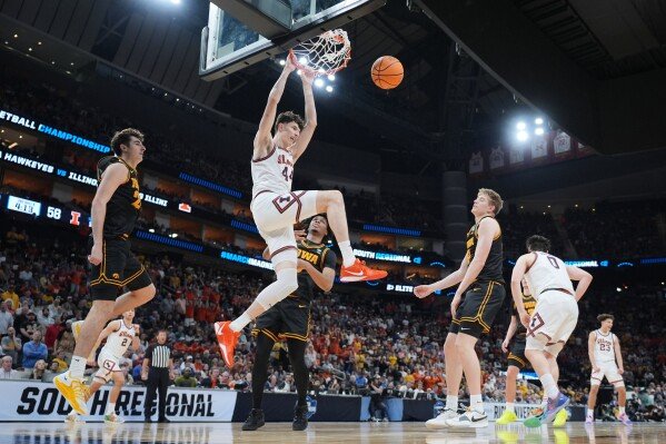 Illinois' Zvonimir Ivisic (44) dunks the ball against Iowa during the second half of an Elite Eight game in the NCAA college basketball tournament Saturday, March 28, 2026, in Houston. (AP Photo/Eric Gay)