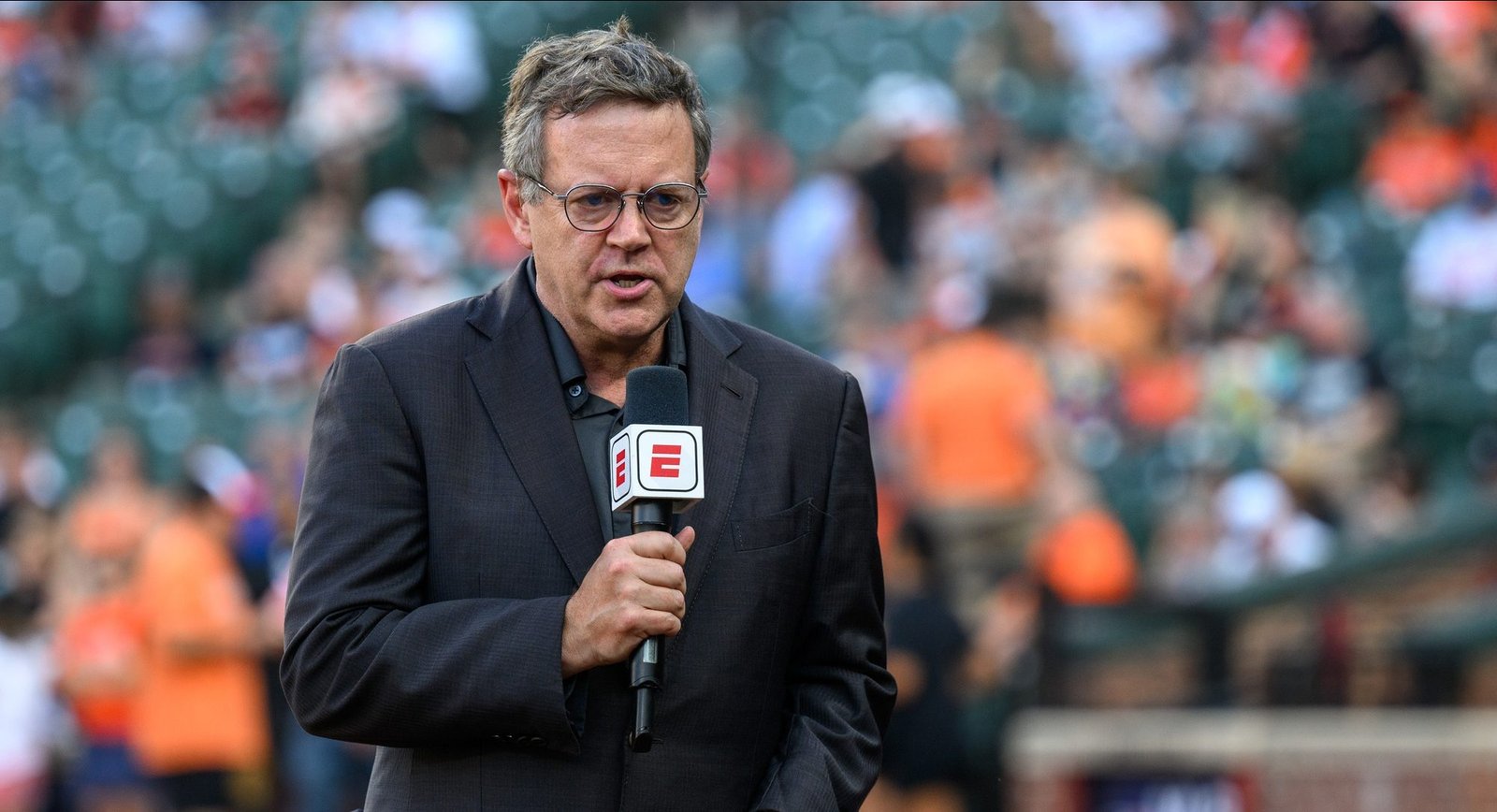 Sports journalist Buster Olney in action before the game between the Baltimore Orioles and the Texas Rangers at Oriole Park at Camden Yards.