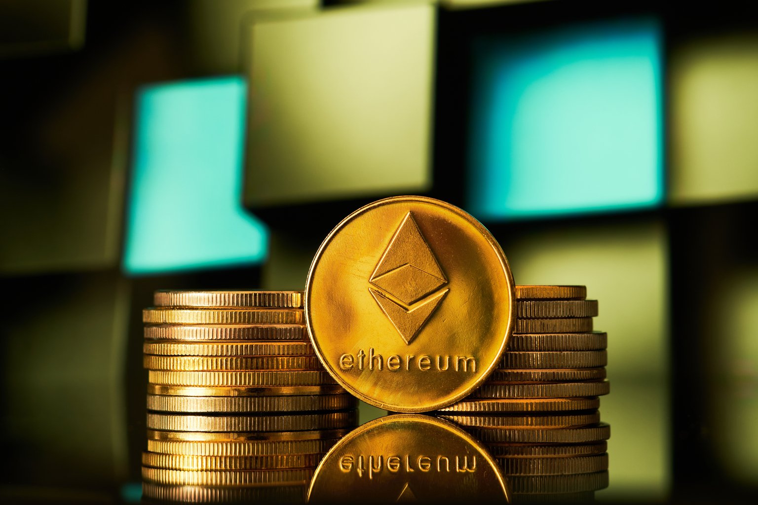Golden ethereum cryptocurrencies stacked on a geometric background reflecting light