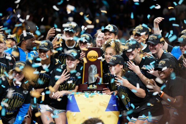 UCLA players celebrate after defeating South Carolina in the women's National Championship Final Four NCAA college basketball tournament game, Sunday, April 5, 2026, in Phoenix. (AP Photo/Ross D. Franklin)