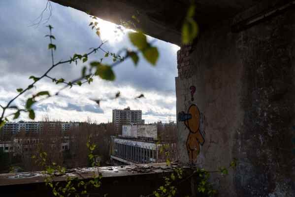 Abandoned houses are seen overgrown with vegetation at the Chernobyl exclusion zone in Prypiat, Ukraine, Monday, April 6, 2026. Chornobyl is the Ukrainian name for the city. (AP Photo/Evgeniy Maloletka)