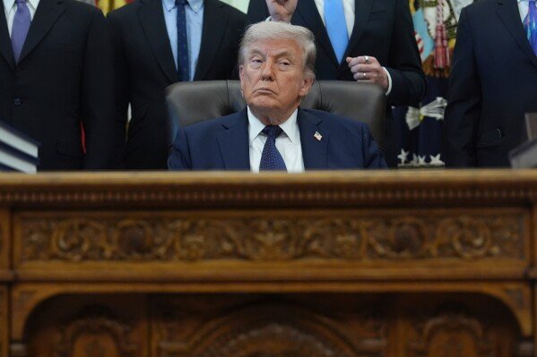 President Donald Trump listens during an event on health care affordability in the Oval Office at the White House, Thursday, April 23, 2026, in Washington. (AP Photo/Mark Schiefelbein)