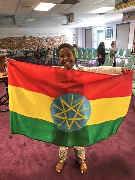 In this photo, Biruk Silvers, holds an Ethiopian flag at school in Northbrook, Ill., on Feb. 9, 2017. (via AP)