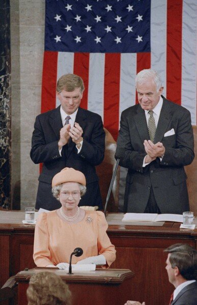 Queen Elizabeth II is applauded by Vice President Dan Quayle and House Speaker Thomas Foley before her address to the U.S. Congress on May 16, 1991 in Washington. (AP Photo/Doug Mills, File)