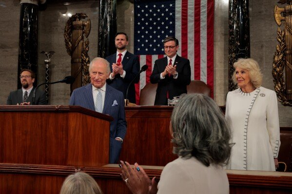 Britain's King Charles III addresses a joint meeting of Congress while Vice President JD Vance, back left, House Speaker Mike Johnson, R-La., back right, applaud and Queen Camilla, right, looks on, in the House Chamber of the U.S. Capitol in Washington, Tuesday, April 28, 2026. (Kylie Cooper/Pool via AP)