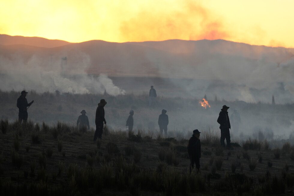 a-photo-captures-tear-gas-drifting-across-a-mountain-road-during-bolivia-protests