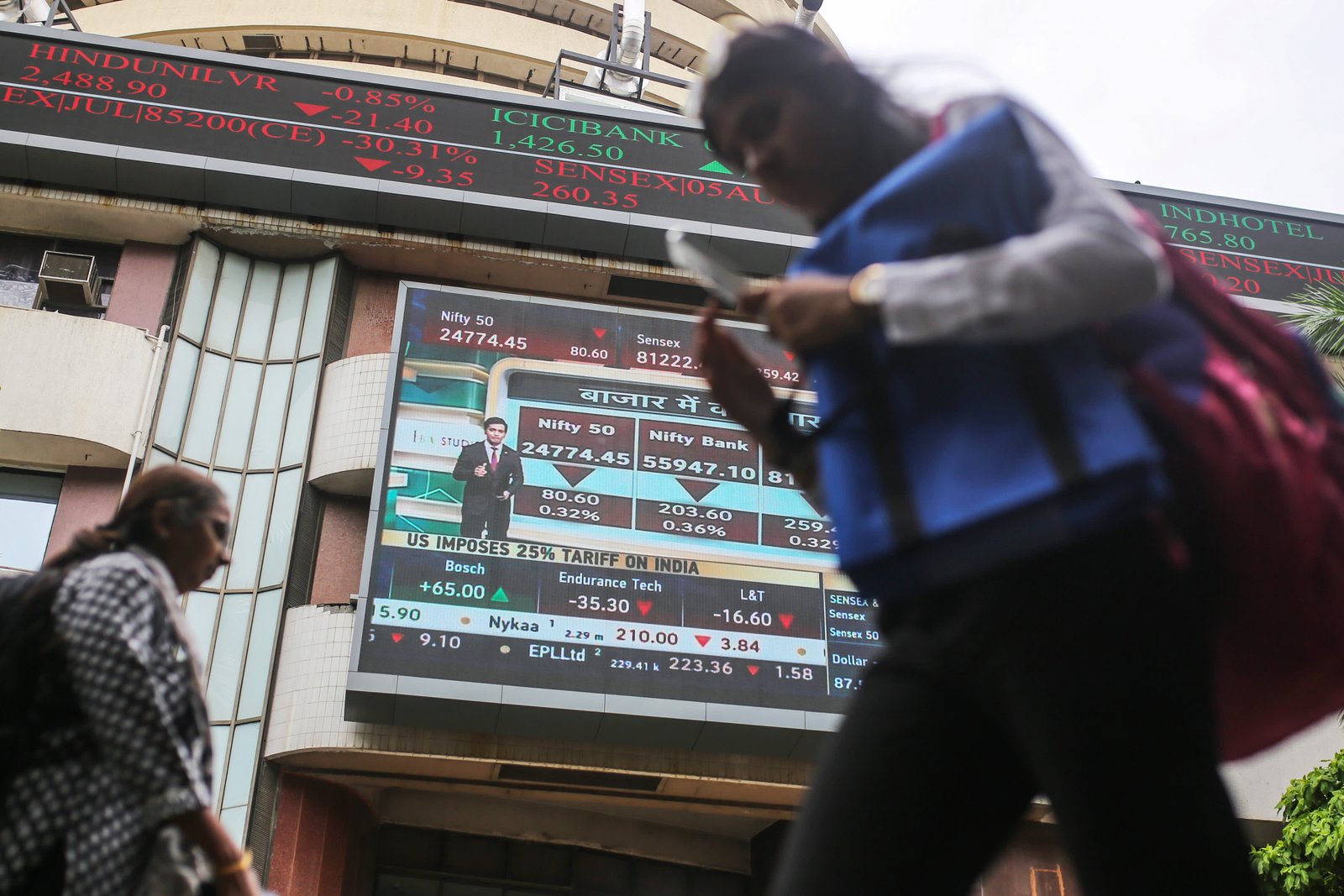 A ticker and a screen display stock prices at the Bombay Stock Exchange (BSE) building in Mumbai, India, on Thursday, July 31, 2025. Photographer: Dhiraj Singh/Bloomberg via Getty Images