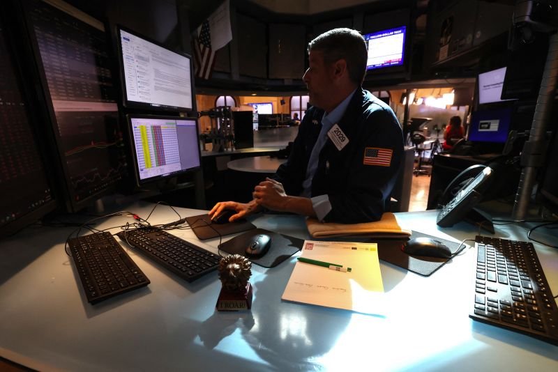 A trader works at his desk on the floor of the New York Stock Exchange on May 19, 2026.