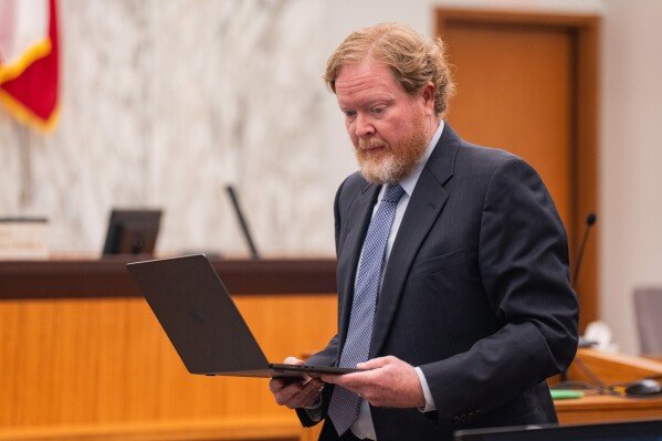 Attorney Ryan Chapple, representing relatives of the victims of the 2012 Sandy Hook School shooting, appears during a hearing on the proposed licensing agreement for The Onion to take control over Alex Jones' Infowars at the Travis County District Court in Austin, Thursday, April 30, 2026. (Mikala Compton/Austin American-Statesman via AP)