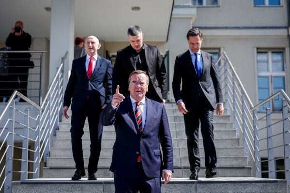 Germany's Minister of Defense Boris Pistorius, front, Britain's Secretary of Defense John Healey, rear left, Ukraine's Minister of Defense Mykhailo Fedorov and Secretary General of NATO Mark Rutte, rear right, gather for a photo at the Ukraine Contact Group meeting in front of the Federal Ministry of Defense in Berlin, April 15, 2026. (Kay Nietfeld/dpa via AP, File)