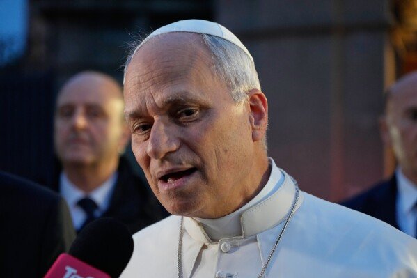 Pope Leo XIV talks to journalists as he leaves his residence in Castel Gandolfo, on the outskirts of Rome, to return to the Vatican, Tuesday, May 5, 2026. (AP Photo/Gregorio Borgia)