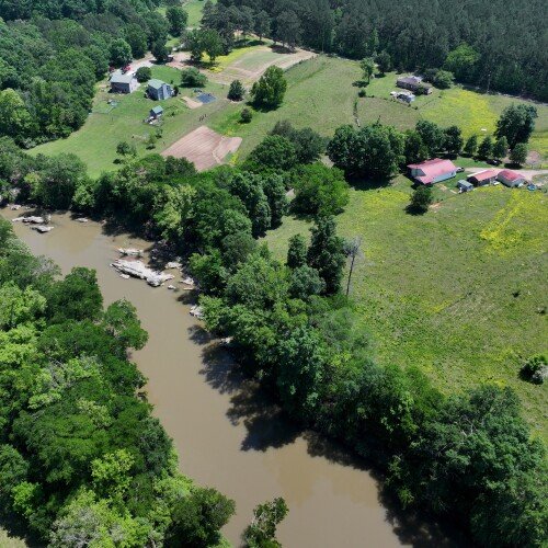 Faye Jackson has lived for decades on a patch of rural land, right, in Resaca, Ga., on the banks of the Conasauga River, seen on Thursday, May 8, 2025. (Hyosub Shin/Atlanta Journal-Constitution via AP)