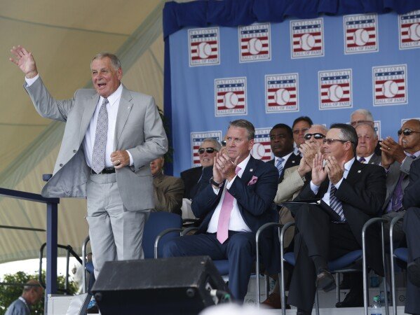 National Baseball Hall of Fame inductee Bobby Cox waves to fans during an induction ceremony at the Clark Sports Center on July 27, 2014, in Cooperstown, N.Y. (AP Photo/Mike Groll, File)