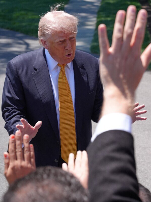 President Donald Trump talks with reporters as he departs the White House for travel to Beijing, Tuesday, May 12, 2026, in Washington, to meet with China's President Xi Jinping. (AP Photo/Jacquelyn Martin)