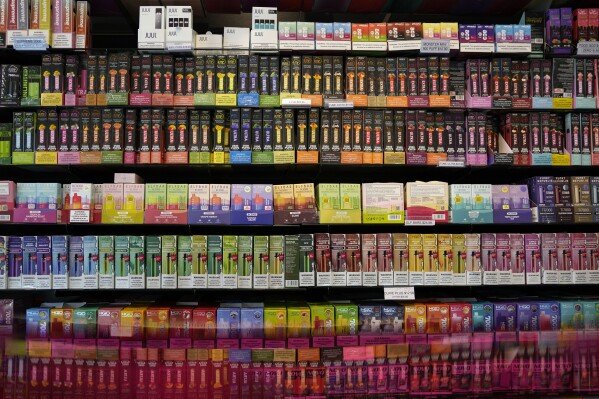 Disposable flavored electronic cigarette devices are displayed for sale at a store in Pinecrest, Fla., June 26, 2023. (AP Photo/Rebecca Blackwell, File)