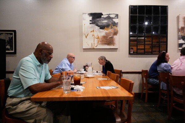 Supporters of U.S. Senate candidate, current Louisiana treasurer and former U.S. Representative (R-La.) John Fleming, wait for him to speak at a Ronald Reagan Newsmaker Luncheon in Baton Rouge, La., Tuesday, May 12, 2026. (AP Photo/Gerald Herbert)