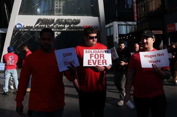 Long Island Rail Road workers walk on the picket line outside of Penn Station on the first day of their strike, Saturday, May 16, 2026, in New York. (AP Photo/Heather Khalifa)