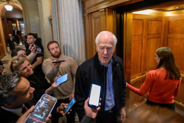 Sen. John Cornyn, R-Texas, talks with reporters as he leaves the Senate chamber during a Senate war powers vote on Capitol Hill, March 4, 2026, in Washington. (AP Photo/Rod Lamkey, Jr., File)