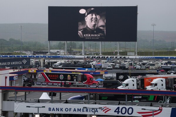 An in memoriam photo of former driver Kyle Busch is displayed on the video board of the backstretch at Charlotte Motor Speedway, Friday, May 22, 2026, in Charlotte, N.C. (AP Photo/Matt Kelley)