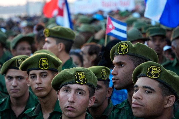 Members of the Revolutionary Armed Forces attend a rally in support of former President Raul Castro in front of the U.S. Embassy in Havana, Cuba, Friday, May 22, 2026, after U.S. prosecutors filed an indictment accusing him of ordering the 1996 shootdown of civilian planes flown by Miami-based exiles. (AP Photo/Ramon Espinosa)