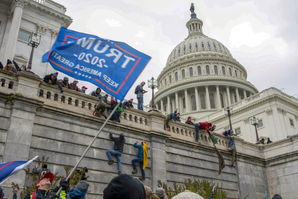 Support of President Donald Trump climb the West Wall of the the U.S. Capitol on Jan. 6, 2021, in Washington. (AP Photo/Jose Luis Magana, File)