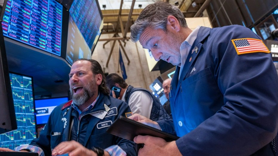 Traders work on the floor of the New York Stock Exchange.