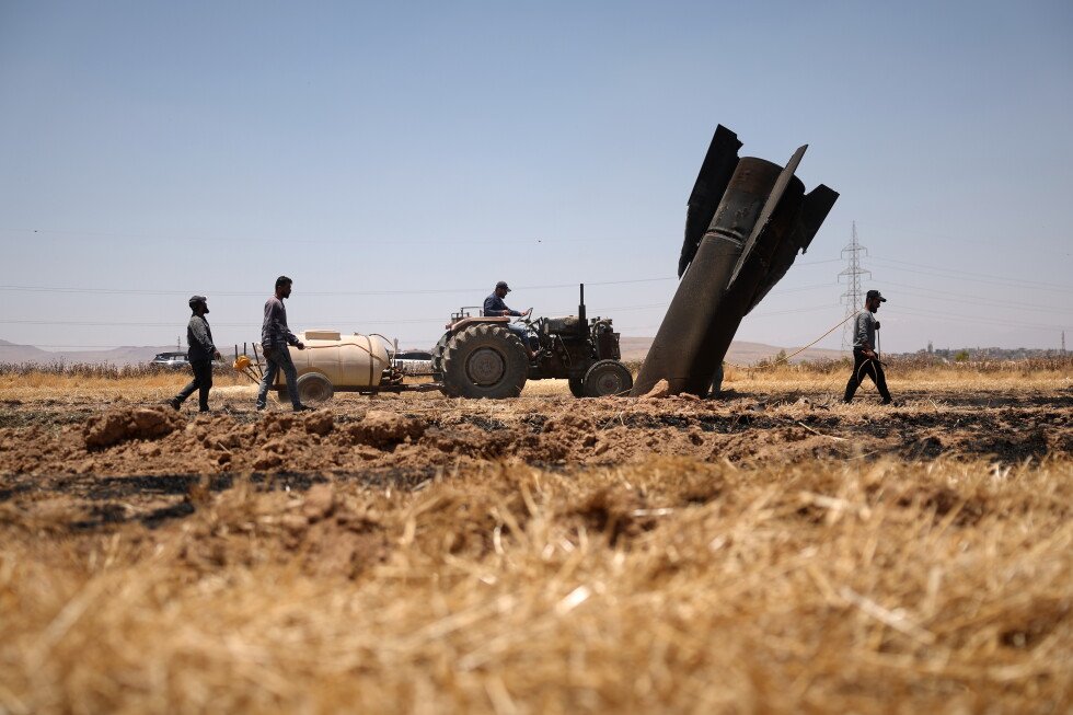 how-a-syrian-farmer,-a-burning-field-and-missile-debris-came-together-in-one-frame