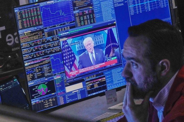 President Donald Trump appears on a trader's screen on the floor of the New York Stock Exchange, Friday, Feb. 20, 2026. 