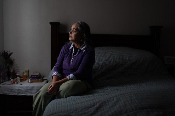 Masuma Khan, an immigrant from Bangladesh who was held at an immigration detention facility in California City the previous year, sits for a photo in her bedroom in Altadena, Calif., April 21, 2026. (AP Photo/Jae C. Hong)