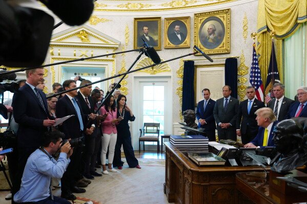 President Donald Trump, seated at right, speaks with reporters at an event about coal, Thursday, June 4, 2026, in the Oval Office of the White House in Washington. (AP Photo/Julia Demaree Nikhinson)