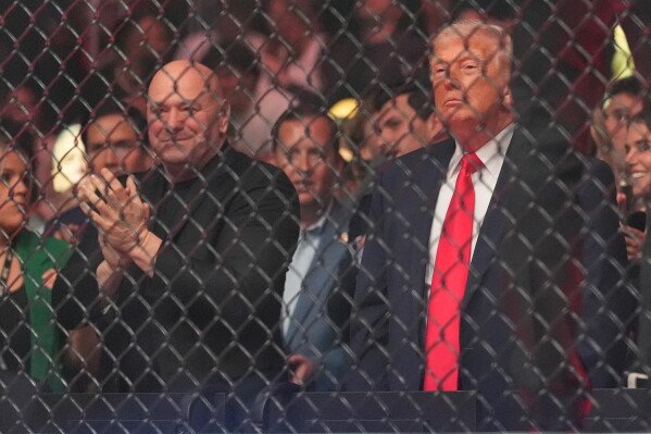 President Donald Trump attends UFC 327 at Kaseya Center, Saturday, April 11, 2026, in Miami, with Dana White. (AP Photo/Rebecca Blackwell)