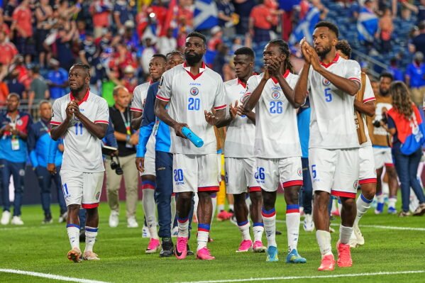 Haiti players react to fans following the World Cup Group C soccer match between Haiti and Scotland in Foxborough, Mass., near Boston, Saturday, June 13, 2026. (AP Photo/Martin Meissner)