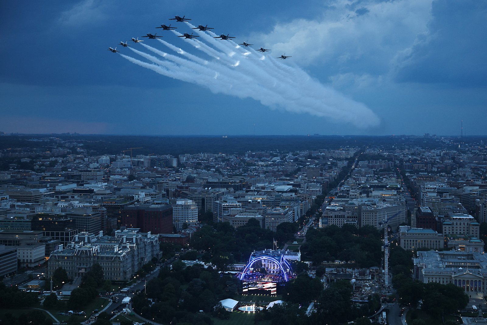 TOPSHOT - US Air Force Thunderbirds and the US Navy Blue Angels perform a flyover during the National Anthem at UFC Freedom 250 on the South Lawn of the White House, in Washington, DC, on June 14, 2026. (Photo by Win McNamee / POOL / AFP via Getty Images)