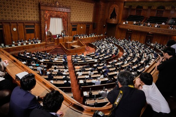 Lawmakers of Japan's Upper House vote on a bill to revise the Imperial House Law during its plenary session in Tokyo, Friday, July 17, 2026. (AP Photo/Eugene Hoshiko)