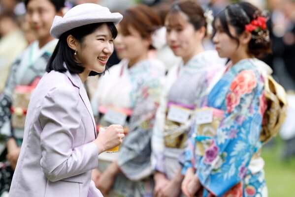 Japan's Princess Aiko, left, daughter of Emperor Naruhito and Empress Masako, speaks with Japanese medalists of the Milan Cortina Winter Olympics during a spring imperial garden party hosted by her parents at Akasaka Palace imperial garden in Tokyo, Friday, April 17, 2026. (Franck Robichon/Pool Photo via AP)