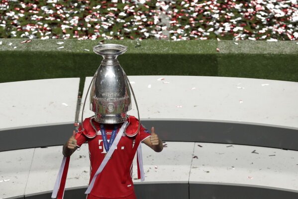 Bayern's Lucas Hernandez celebrates with the trophy after the Champions League final soccer match between Paris Saint-Germain and Bayern Munich at the Luz stadium in Lisbon, Portugal, Sunday, Aug. 23, 2020. (AP Photo/Manu Fernandez, Pool)