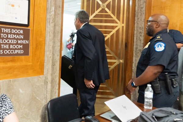 David Schertler, Dr. Anthony Fauci’s defense lawyer, is escorted out, as Fauci appears before the Senate Homeland Security and Governmental Affairs Committee at the Capitol, Wednesday, July 29, 2026, in Washington.  (AP Photo/Manuel Balce Ceneta)