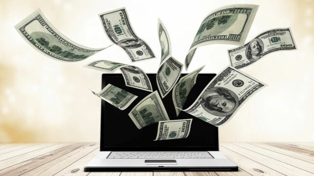 Money flying out of computer screen