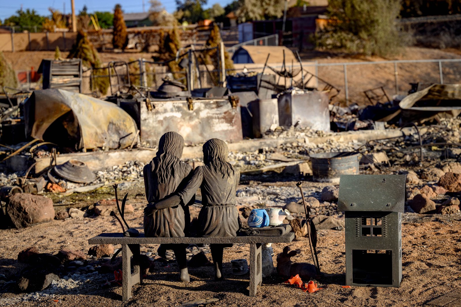 TOPSHOT - A statue is left amid the remains of a home burned by the Hawk Fire in Reno, Nevada on August 24, 2026. Tens of thousands of people looked set to spend another night away from home on August 24 as a wind-driven fire bore down on the western US city of Reno. Schools were shuttered as smoke swathed the city in Nevada, near the California border, home to around 280,000 people. Around 24,000 were still under evacuation orders on Monday, officials said, down from over 40,000 at its peak. (Photo by Josh Edelson / AFP via Getty Images)