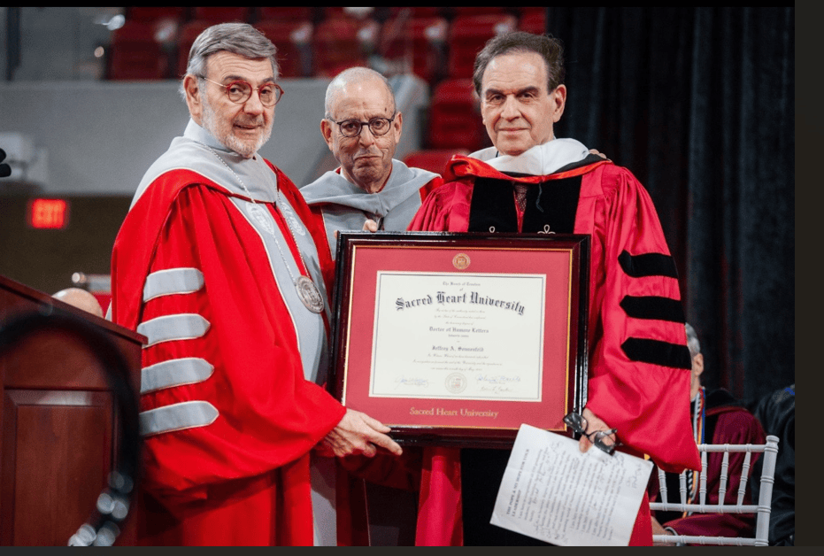 Well-known Yale professor Jeffrey Sonnenfeld conducted a study of Connecticut's pension fund and found it had been among the poorest performing in the country before a recent turnround that included double-digit increases for three straight years and then an increase of 15% in the last fiscal year. He is shown here with Sacred Heart President John J. Petillo and trustee James T. Morely as he receives an honorary degree in October 2024 in Fairfield.(Photo by Isabella Giansanti)