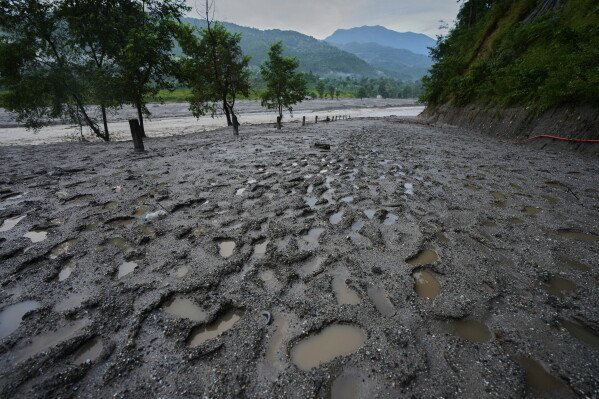 Footprints of rescuers are seen on banks of the swollen river Trishuli after flash floods in Bidur in Nuwakot district of Nepal, Monday, Aug. 31, 2026. (AP Photo/Rajesh Kumar Singh)