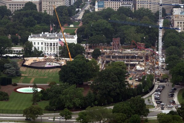 Construction on a helipad on the South Lawn and the former East Wing of the White House is seen from the Washington Monument, July 10, 2026, in Washington. (AP Photo/Mark Schiefelbein, File)