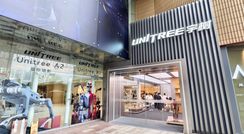 Visitors look at humanoid robots and robot dogs at the Unitree Robotics Embodied Intelligence Experience Store on August 19, 2026 in Shanghai, China.